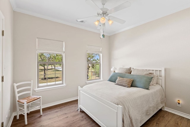 2409 Mormon Mill Rd, Marble Falls, TX 78654 - bedroom featuring wood finished floors, visible vents, crown molding, and baseboards