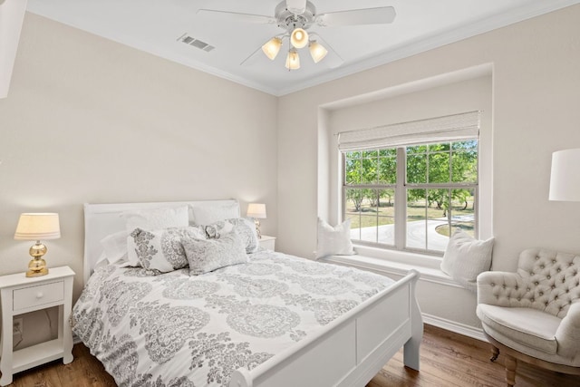 2409 Mormon Mill Rd, Marble Falls, TX 78654 - bedroom featuring a ceiling fan, crown molding, wood finished floors, baseboards, and visible vents