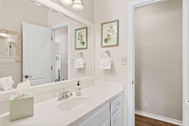 2409 Mormon Mill Rd, Marble Falls, TX 78654 - bathroom featuring baseboards, wood finished floors, and vanity