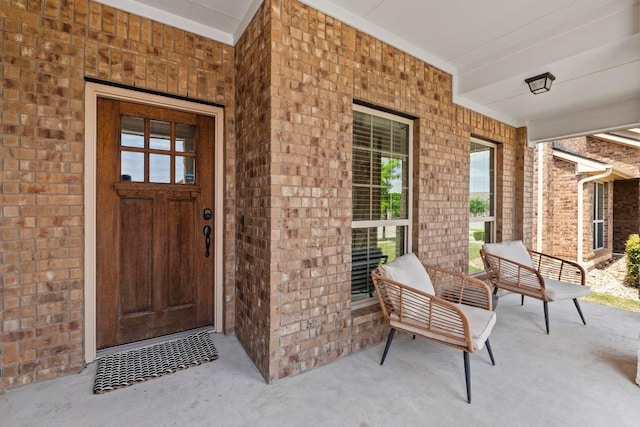11928 Arran St, Austin, TX 78754 - doorway to property with brick siding and covered porch