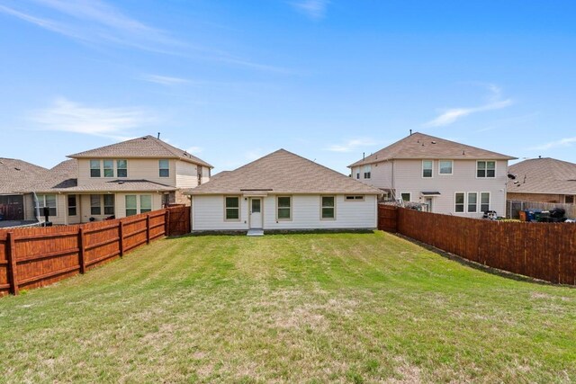 11928 Arran St, Austin, TX 78754 - rear view of house featuring a lawn and a fenced backyard