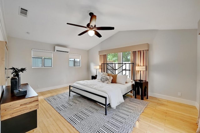 702 W Mary St, Austin, TX 78704 - bedroom featuring a wall unit AC, wood finished floors, baseboards, vaulted ceiling, and a ceiling fan