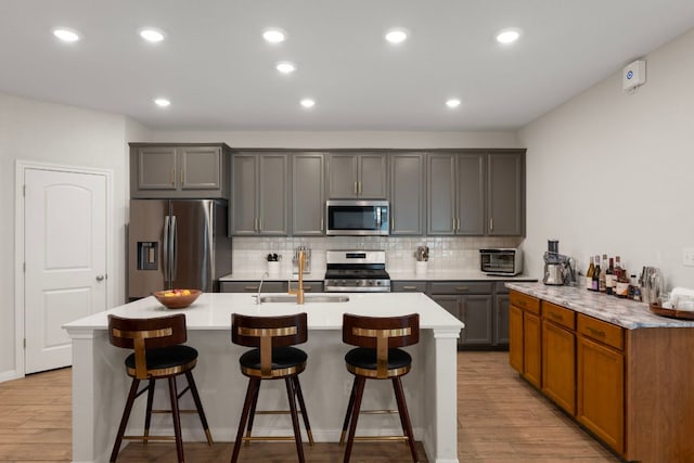 1921 Winston Way, Leander, TX 78641 - kitchen with appliances with stainless steel finishes, light countertops, light wood finished floors, and recessed lighting