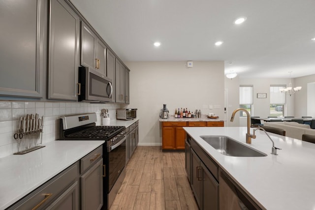 1921 Winston Way, Leander, TX 78641 - kitchen with stainless steel appliances, light wood-type flooring, recessed lighting, light countertops, and decorative backsplash
