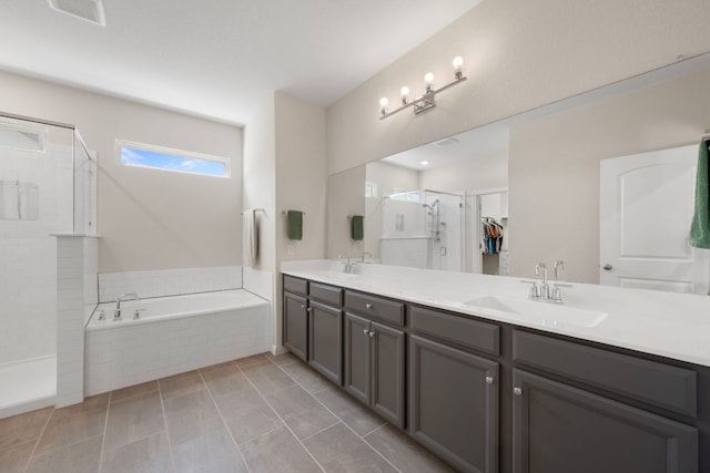 1921 Winston Way, Leander, TX 78641 - bathroom with double vanity, a garden tub, a tile shower, and a spacious closet