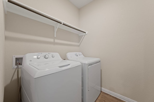 1921 Winston Way, Leander, TX 78641 - laundry room featuring washing machine and dryer and wood finished floors