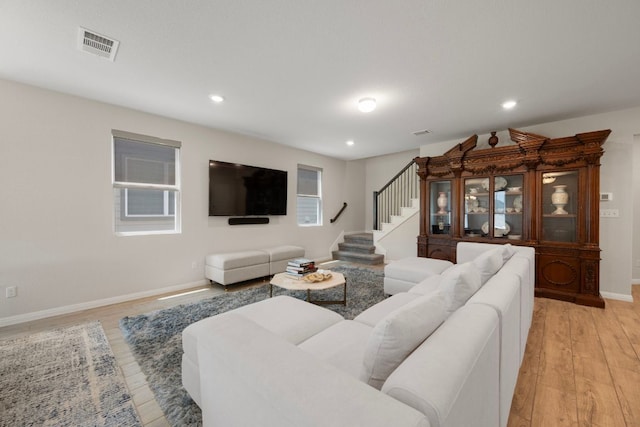 1921 Winston Way, Leander, TX 78641 - living room featuring light wood-style floors, stairs, and recessed lighting