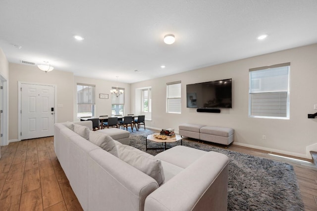 1921 Winston Way, Leander, TX 78641 - living room featuring wood finished floors, a chandelier, and recessed lighting