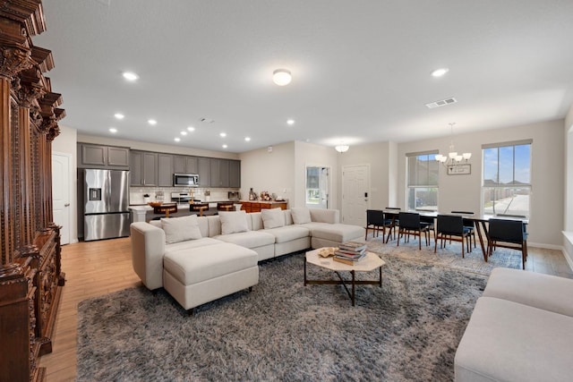 1921 Winston Way, Leander, TX 78641 - living room featuring a chandelier, light wood-style floors, and recessed lighting
