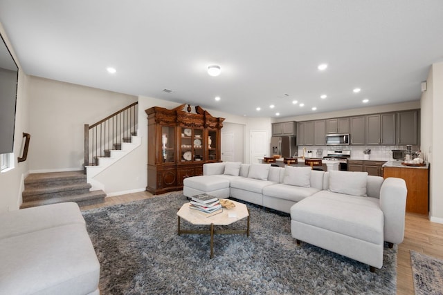 1921 Winston Way, Leander, TX 78641 - living room featuring light wood-style floors, stairway, and recessed lighting