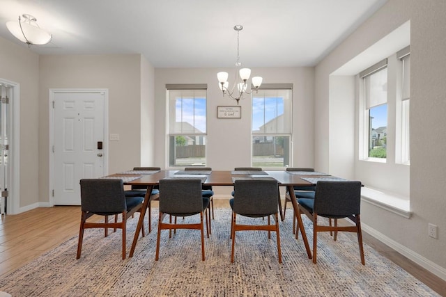 1921 Winston Way, Leander, TX 78641 - dining space with light wood-style flooring and a chandelier