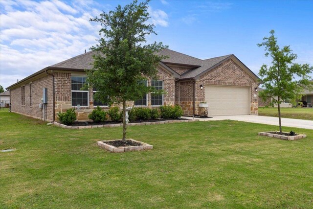 109 Sandpiper Dr, Bastrop, TX 78602 - view of front of property featuring an attached garage, driveway, brick siding, and a front yard