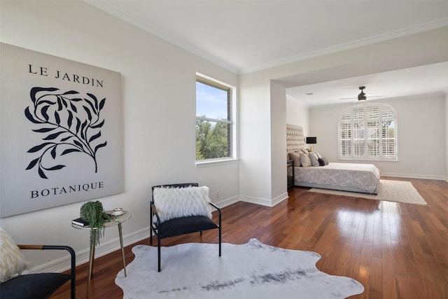bedroom with baseboards, crown molding, and wood finished floors