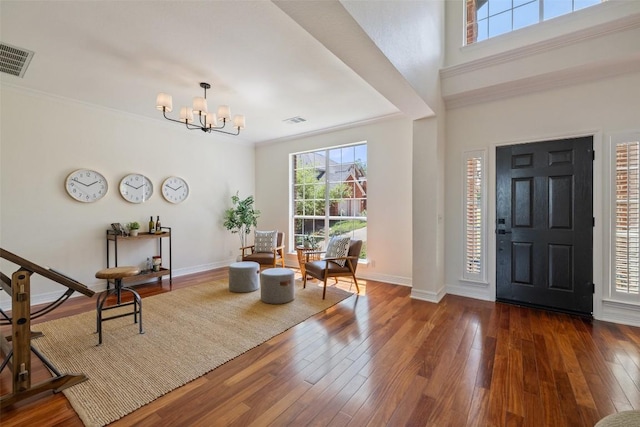 12400 Fairfax Ridge Pl, Austin, TX 78738 - foyer featuring healthy amount of natural light, a chandelier, wood-type flooring, and ornamental molding