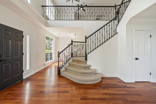 12400 Fairfax Ridge Pl, Austin, TX 78738 - entrance foyer with stairs, wood finished floors, a towering ceiling, baseboards, and a chandelier