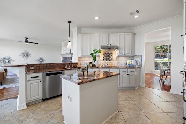 12400 Fairfax Ridge Pl, Austin, TX 78738 - kitchen with dishwasher, a peninsula, a sink, under cabinet range hood, and dark stone countertops