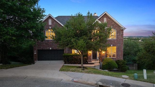 12400 Fairfax Ridge Pl, Austin, TX 78738 - traditional-style house featuring brick siding, an attached garage, a chimney, and driveway