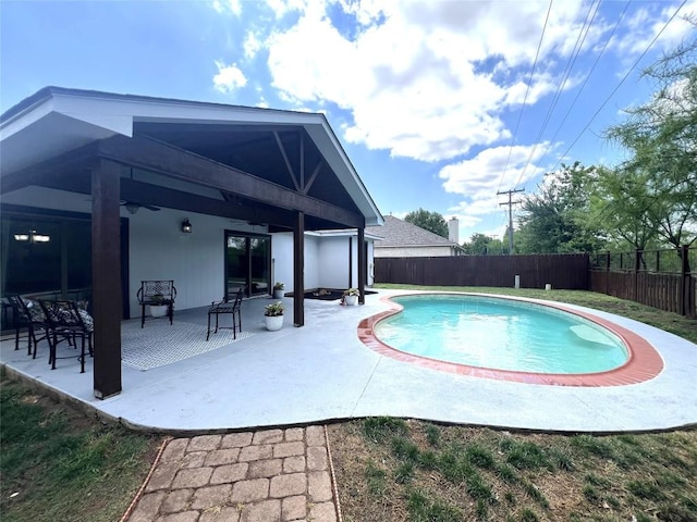 view of swimming pool featuring a fenced in pool, a fenced backyard, ceiling fan, and a patio area