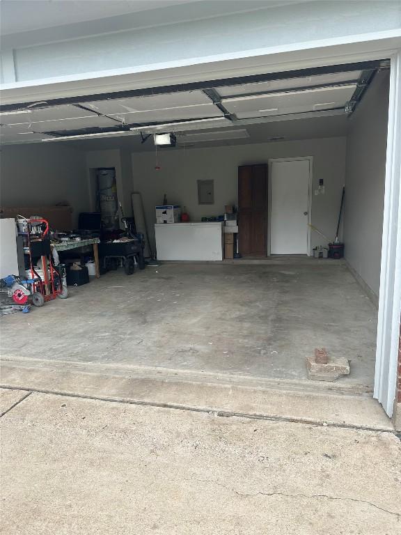 garage featuring a garage door opener and electric panel