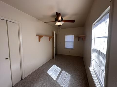 unfurnished bedroom with carpet floors, a closet, and ceiling fan