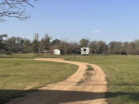 view of property's community featuring driveway and a yard