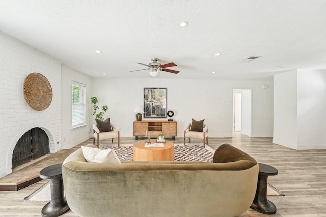 6111 Bridlington Cir, Austin, TX 78745 - living area with light wood-type flooring, a fireplace, a ceiling fan, and recessed lighting