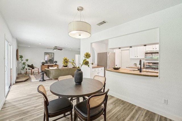 6111 Bridlington Cir, Austin, TX 78745 - dining room featuring light wood-type flooring and a ceiling fan