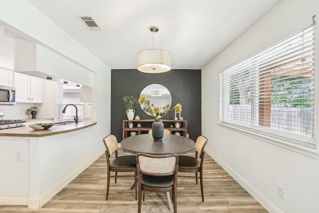 6111 Bridlington Cir, Austin, TX 78745 - dining room featuring an accent wall and light wood-style floors