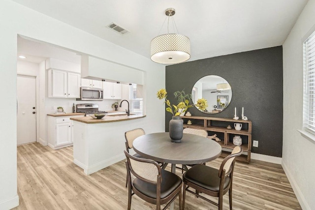 6111 Bridlington Cir, Austin, TX 78745 - dining space featuring light wood finished floors and baseboards