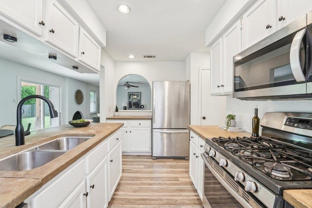6111 Bridlington Cir, Austin, TX 78745 - kitchen featuring appliances with stainless steel finishes, recessed lighting, light wood-style floors, white cabinets, and ceiling fan