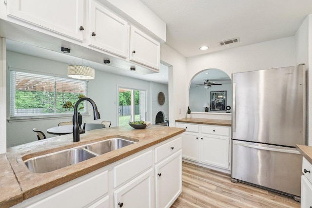 6111 Bridlington Cir, Austin, TX 78745 - kitchen featuring freestanding refrigerator, white cabinetry, ceiling fan, light wood finished floors, and recessed lighting