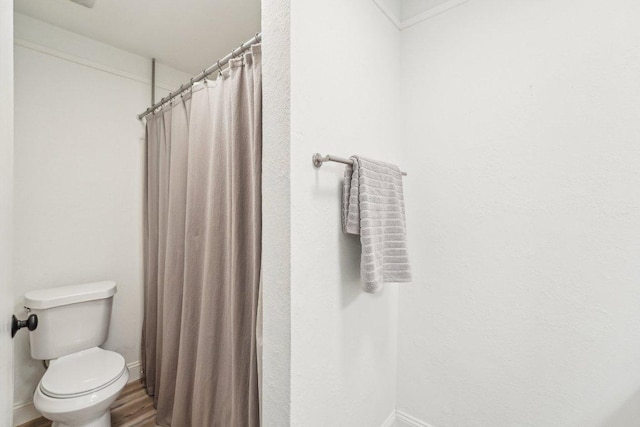 6111 Bridlington Cir, Austin, TX 78745 - bathroom with wood finished floors and a shower with curtain