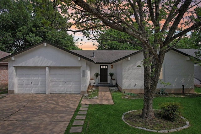 6111 Bridlington Cir, Austin, TX 78745 - view of front of property with driveway, a garage, a yard, and brick siding
