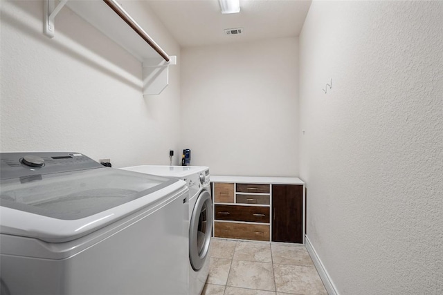 624 Anfield Cir, Austin, TX 78738 - laundry room featuring separate washer and dryer, baseboards, and a textured wall