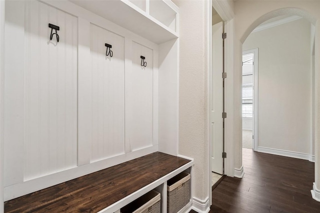 624 Anfield Cir, Austin, TX 78738 - mudroom featuring arched walkways, dark wood-type flooring, and baseboards