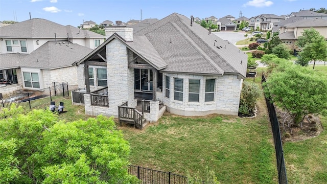 624 Anfield Cir, Austin, TX 78738 - back of property with stone siding, a residential view, a chimney, roof with shingles, and a fenced backyard