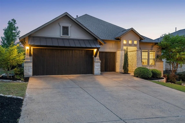 624 Anfield Cir, Austin, TX 78738 - view of front of property with stone siding, a garage, driveway, and a standing seam roof