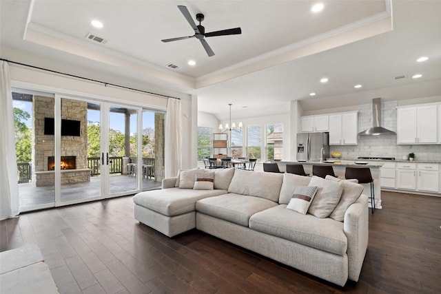 624 Anfield Cir, Austin, TX 78738 - living area featuring a raised ceiling, ornamental molding, dark wood-style floors, recessed lighting, and ceiling fan
