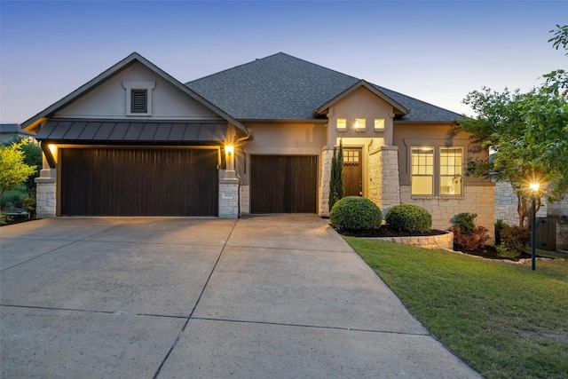624 Anfield Cir, Austin, TX 78738 - view of front of property with an attached garage, stone siding, concrete driveway, a front yard, and a shingled roof