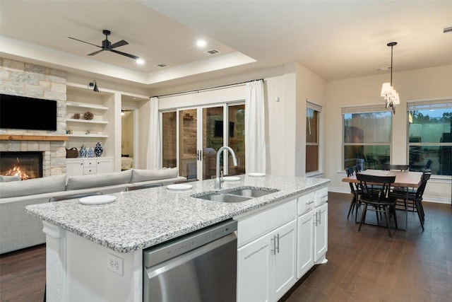 624 Anfield Cir, Austin, TX 78738 - kitchen with dishwasher, a sink, open floor plan, and a raised ceiling