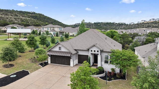 624 Anfield Cir, Austin, TX 78738 - view of front of home with a garage, concrete driveway, a residential view, a front yard, and stone siding