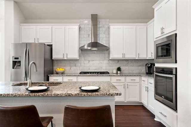 624 Anfield Cir, Austin, TX 78738 - kitchen with appliances with stainless steel finishes, wall chimney exhaust hood, a sink, and white cabinets