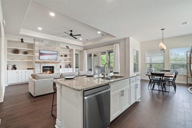 624 Anfield Cir, Austin, TX 78738 - kitchen with dishwasher, a tray ceiling, a sink, healthy amount of natural light, and ornamental molding