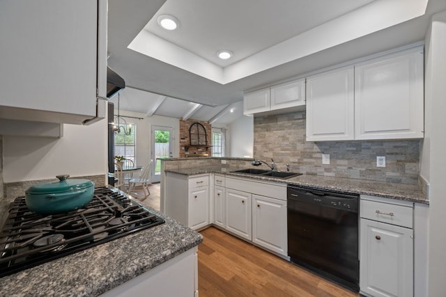 1314 Quailfield Cir, Austin, TX 78758 - kitchen featuring black appliances, a peninsula, light wood-style flooring, and white cabinetry