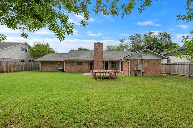 1314 Quailfield Cir, Austin, TX 78758 - back of house featuring brick siding, a chimney, and a fenced backyard