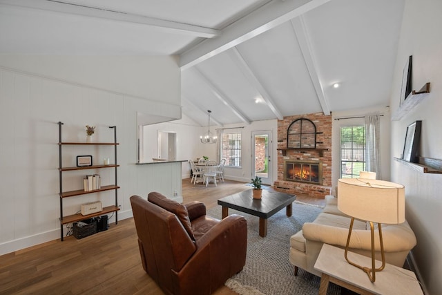 1314 Quailfield Cir, Austin, TX 78758 - living room featuring wood finished floors, a brick fireplace, and a chandelier