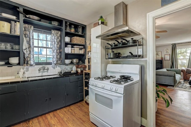 809 E 44th St, Austin, TX 78751 - kitchen featuring white gas stove, exhaust hood, open shelves, and a sink