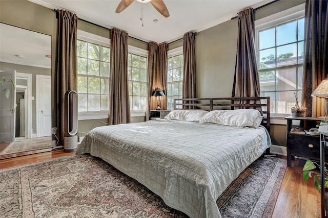 809 E 44th St, Austin, TX 78751 - bedroom featuring wood finished floors, multiple windows, ornamental molding, and ceiling fan