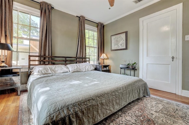 809 E 44th St, Austin, TX 78751 - bedroom with ornamental molding, wood finished floors, and a ceiling fan