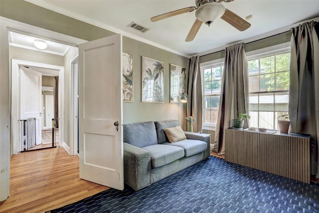809 E 44th St, Austin, TX 78751 - sitting room with ornamental molding, wood finished floors, radiator, and ceiling fan